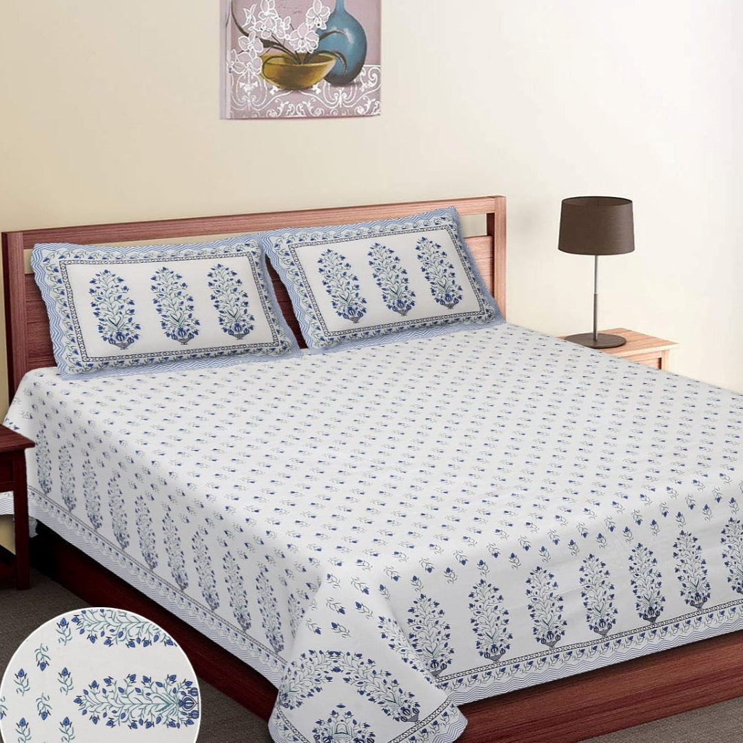 Bed with floral patterned bedspread and matching pillows, with 'Fortune' branding. RESTEZZY