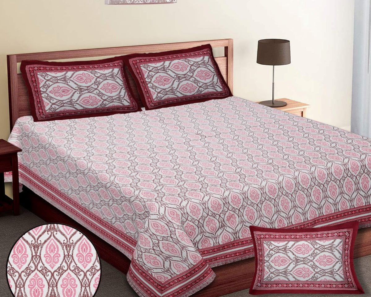 Bed with patterned bedding and pillows in a bedroom setting.