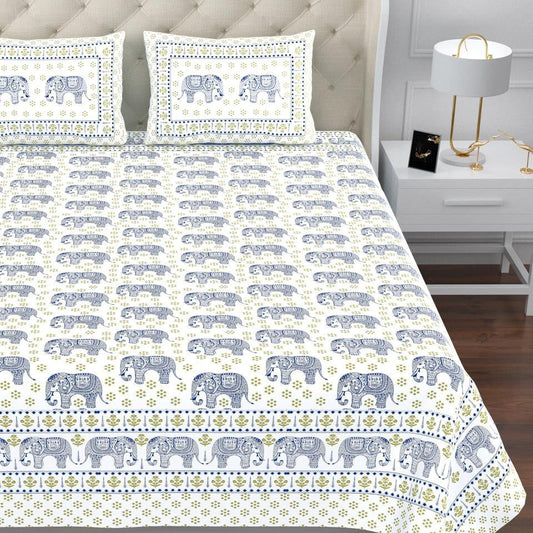 Bed with elephant patterned bedding and pillows in a bedroom setting. RestEzzy