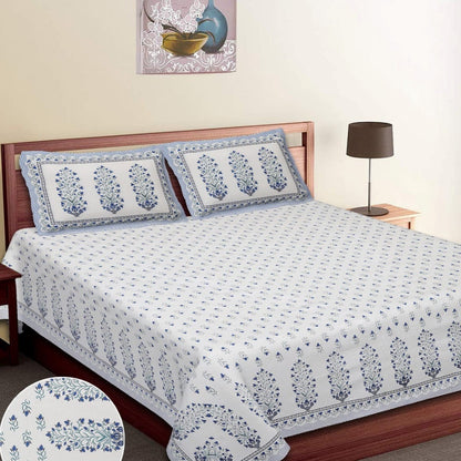 Bed with floral patterned bedspread and matching pillows, with 'Fortune' branding. RESTEZZY
