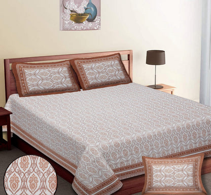 Bed with patterned bedding and pillows in a bedroom setting.  RESTEZZY